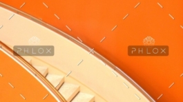 A close up of stairs on an orange wall