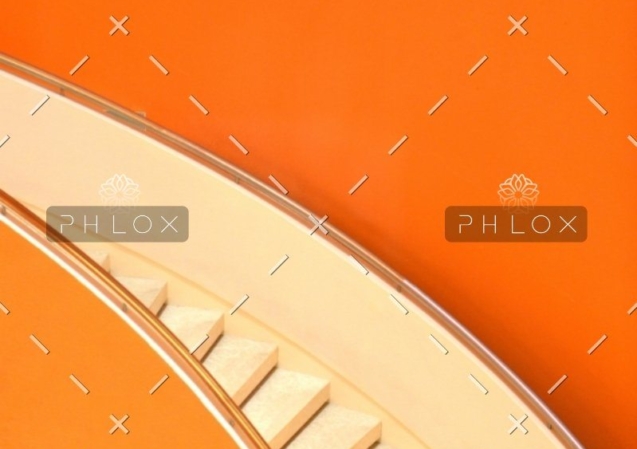 A close up of stairs on an orange wall